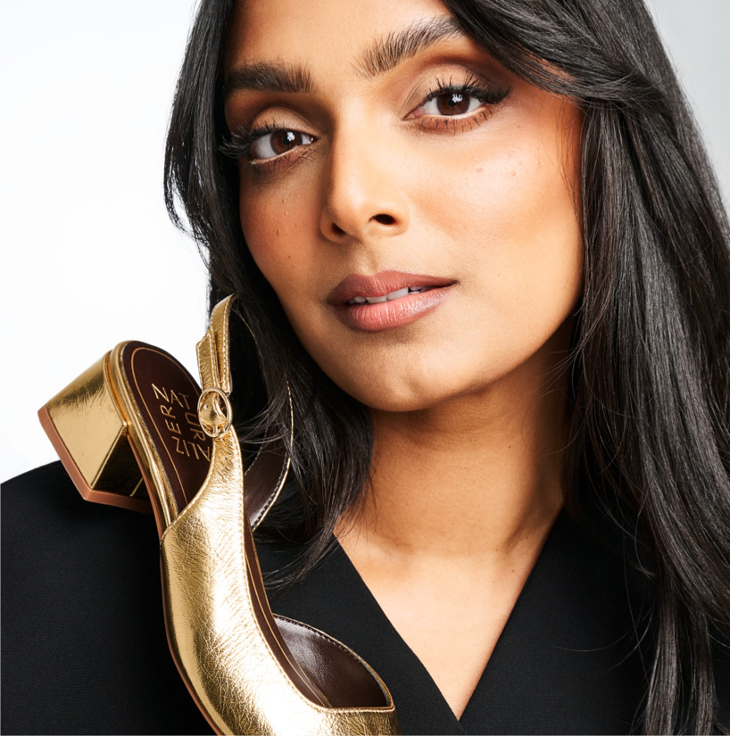 Deepica Mutyala holding a gold Naturalizer shoe